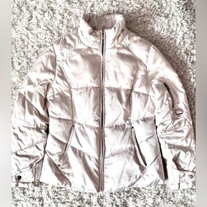 Women’s cream color jacket. No known tears or stains, and zippers run smoothly